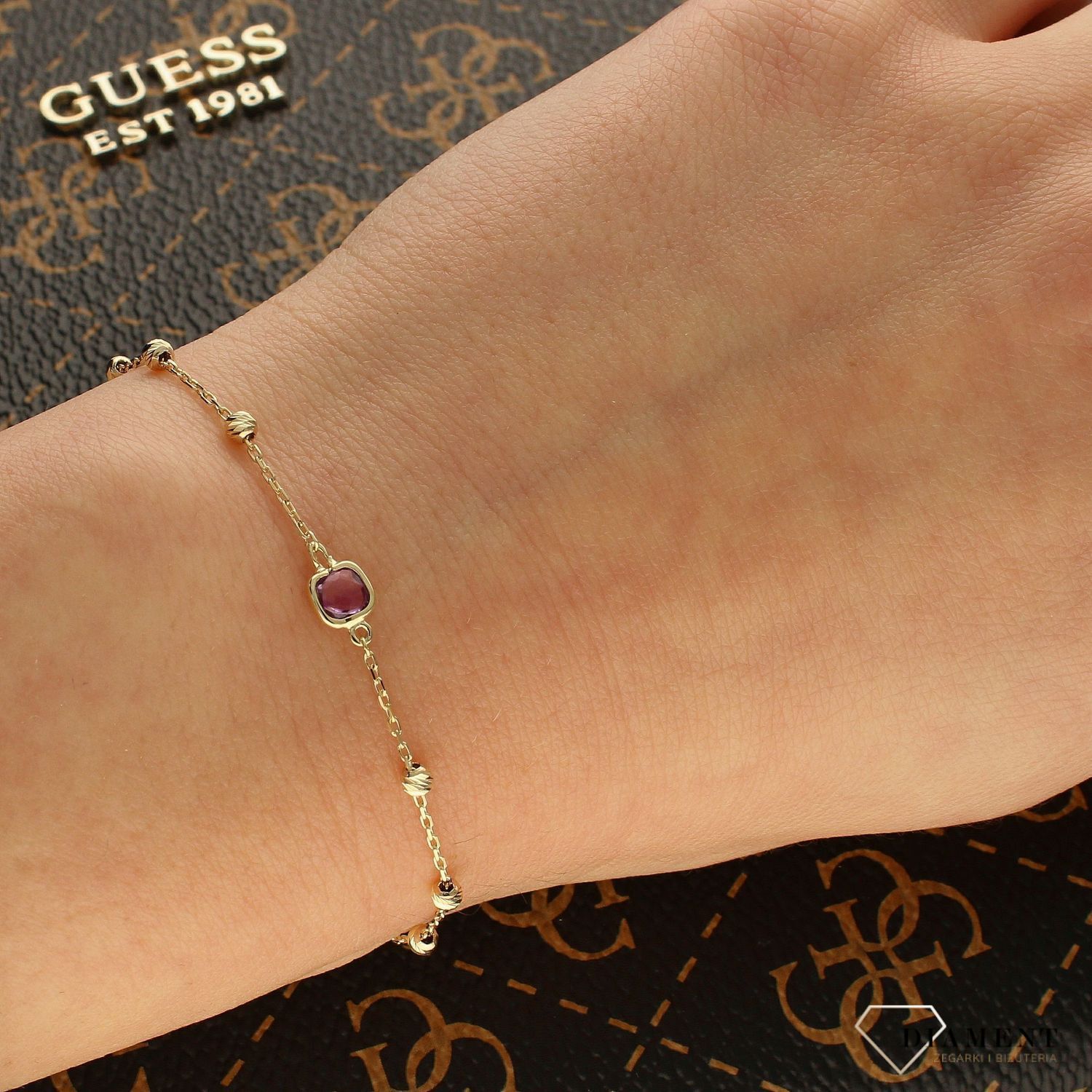 Złota bransoletka celebrytka z fioletowym kamieniem i złotymi kulkami BR 4234.jpg